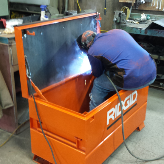 Welder repairing a toolbox.